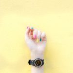 person wearing round black analog watch at 9:46